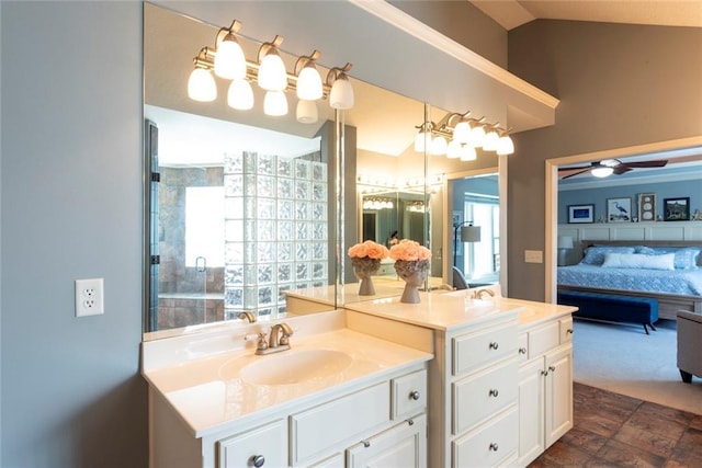 full bathroom with vaulted ceiling, ceiling fan, connected bathroom, and vanity