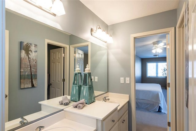 ensuite bathroom featuring ceiling fan, a sink, ensuite bath, and double vanity