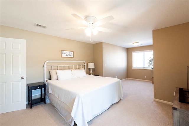 bedroom with visible vents, ceiling fan, light carpet, and baseboards