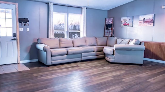 living room featuring lofted ceiling, a textured ceiling, plenty of natural light, and dark wood-type flooring