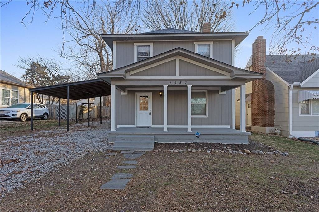 view of front of house featuring a carport and covered porch