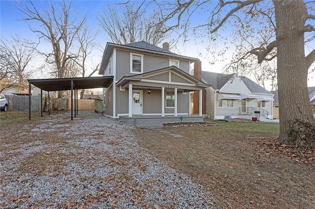 view of front of house featuring a porch and a carport