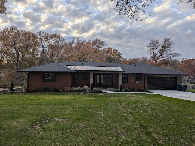 ranch-style home featuring a garage and a front yard