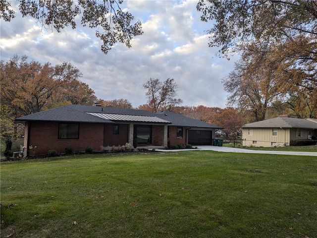 ranch-style house featuring a garage and a front yard