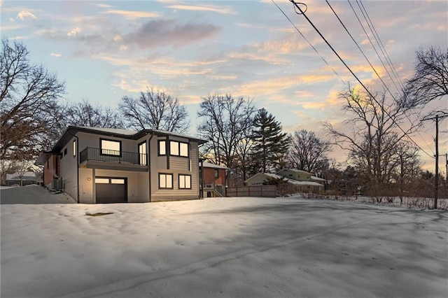 property exterior at dusk featuring a garage