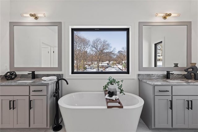 bathroom with a bathing tub and vanity