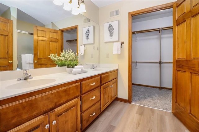 bathroom with vanity, vaulted ceiling, and hardwood / wood-style floors