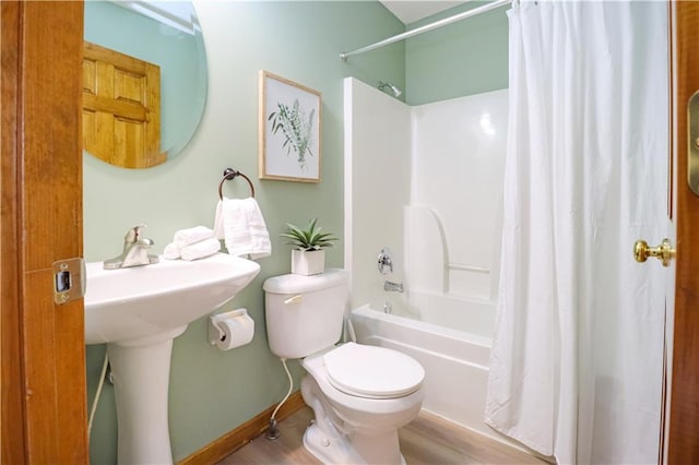 bathroom with shower / bathtub combination with curtain and toilet