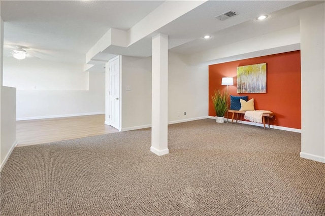 basement with light carpet and ceiling fan