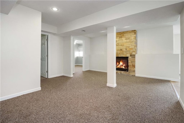 basement with carpet flooring and a fireplace