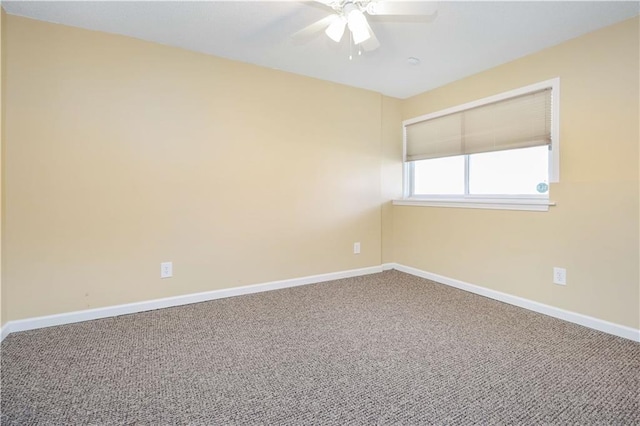 carpeted spare room featuring ceiling fan