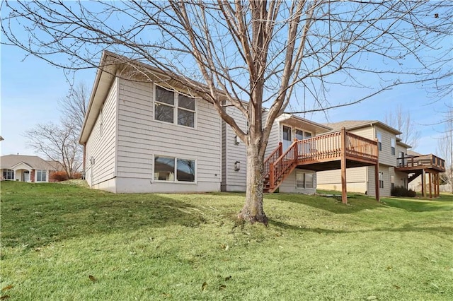 rear view of property with a wooden deck and a yard