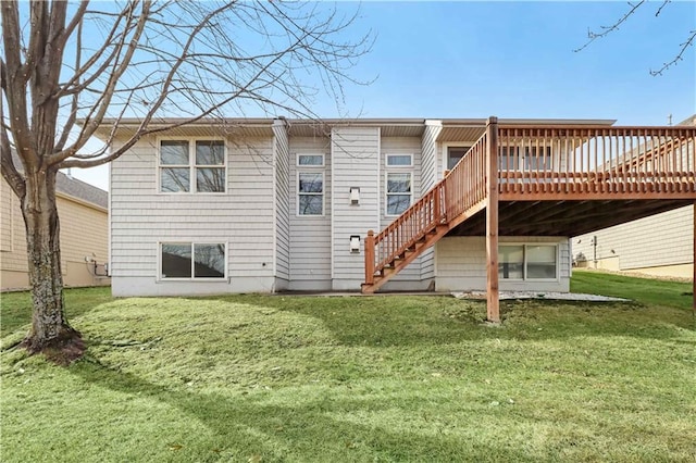 back of house featuring a lawn and a deck