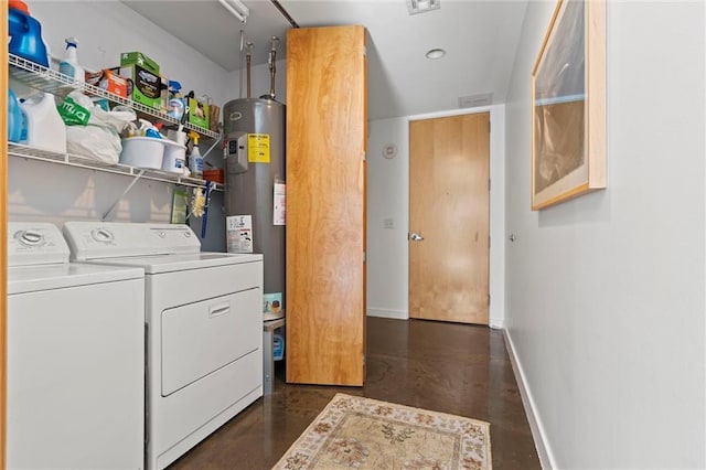 washroom with laundry area, water heater, baseboards, and washing machine and clothes dryer