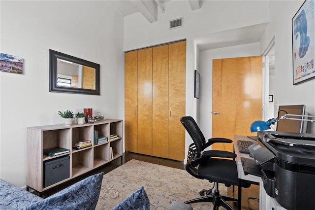 office area with beamed ceiling and visible vents