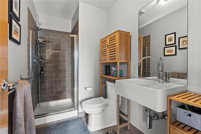 full bathroom with a stall shower, tile patterned flooring, visible vents, and toilet