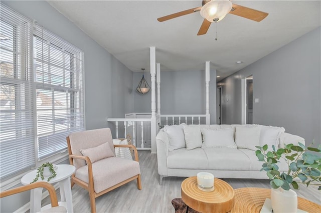 living room featuring wood-type flooring and ceiling fan