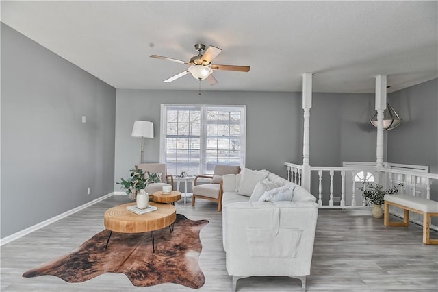 living room with ceiling fan and hardwood / wood-style flooring