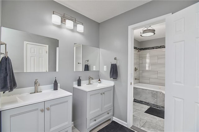 bathroom with tiled shower / bath and vanity