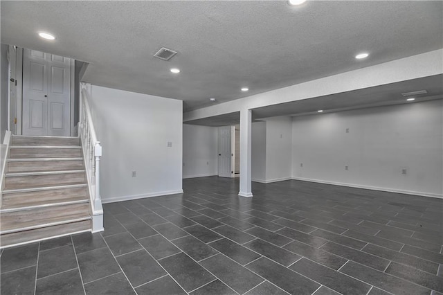 basement featuring a textured ceiling