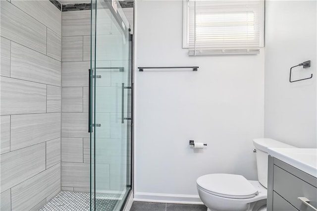 bathroom featuring toilet, an enclosed shower, and vanity