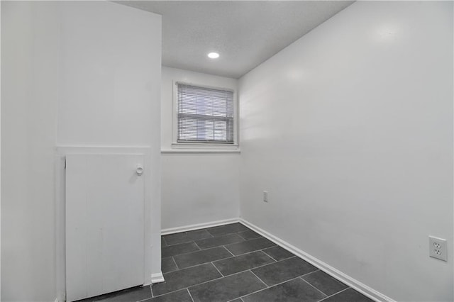 empty room featuring dark tile patterned floors