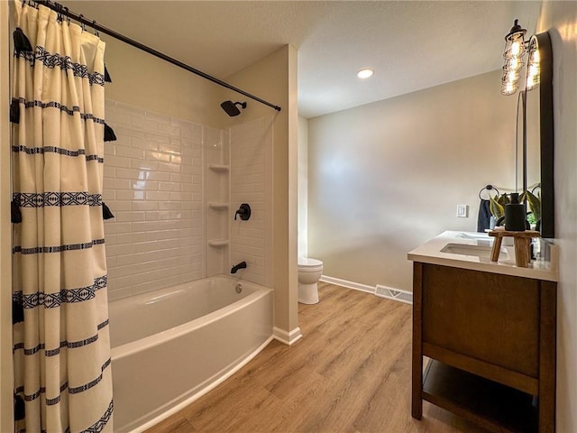 full bathroom featuring vanity, wood-type flooring, toilet, and shower / bathtub combination with curtain