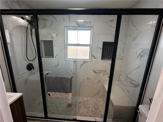 bathroom featuring vanity, toilet, and an enclosed shower