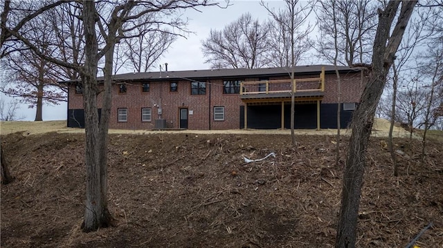 back of house with central AC and a deck