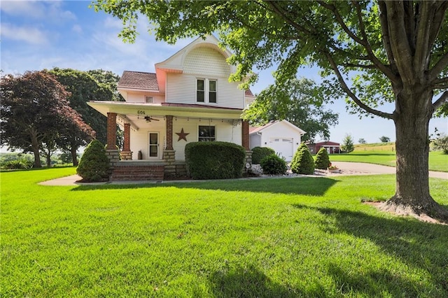 view of front of home with a front lawn, a garage, and a porch