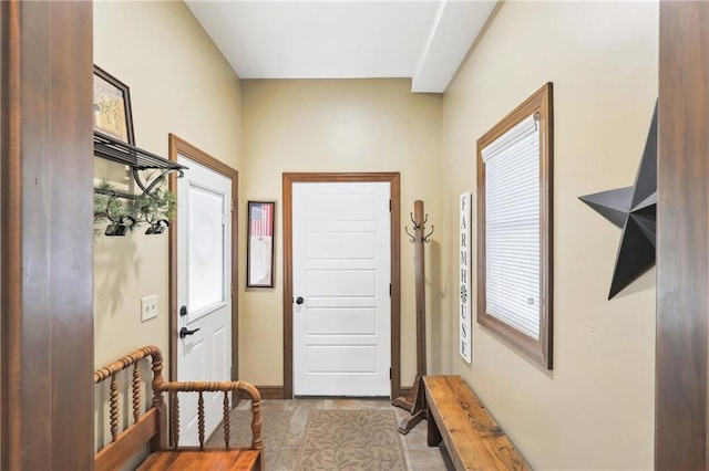 doorway to outside with light tile patterned floors