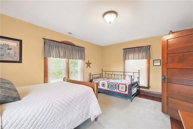 bedroom featuring light colored carpet