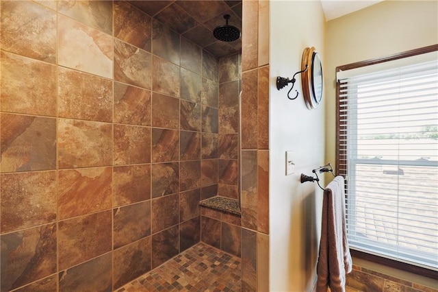 bathroom with a tile shower