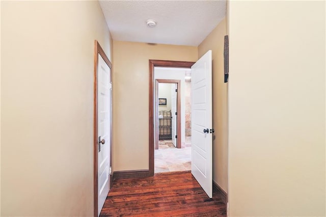 hall with dark wood-type flooring