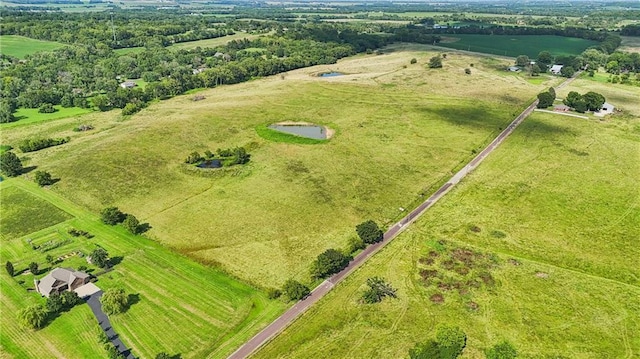 birds eye view of property with a rural view