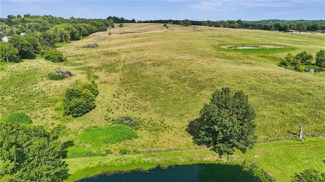 drone / aerial view featuring a water view and a rural view