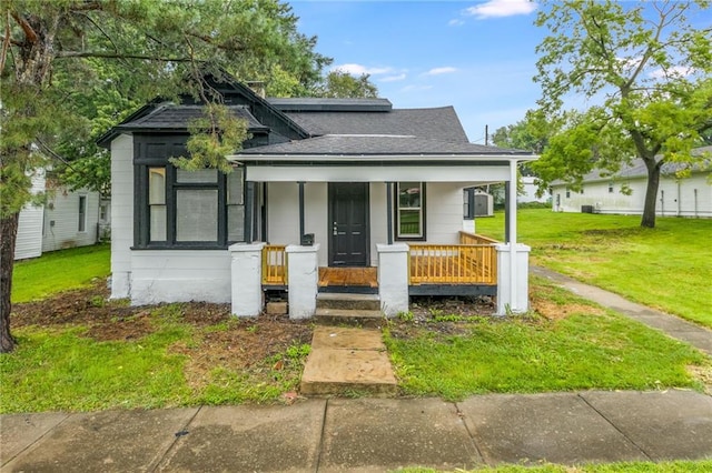 bungalow-style house featuring a porch and a front lawn