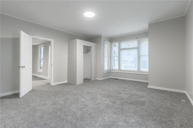 carpeted empty room with ornamental molding