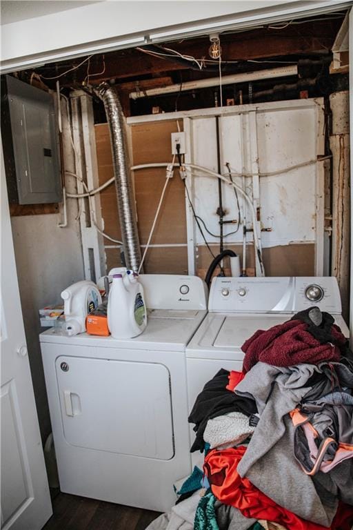 laundry area featuring washing machine and dryer, dark wood-type flooring, and electric panel