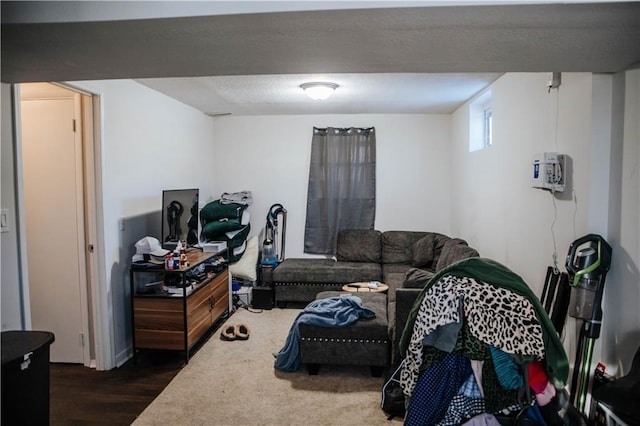 living room with dark wood-type flooring and a textured ceiling