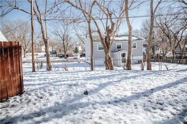 view of snow covered rear of property