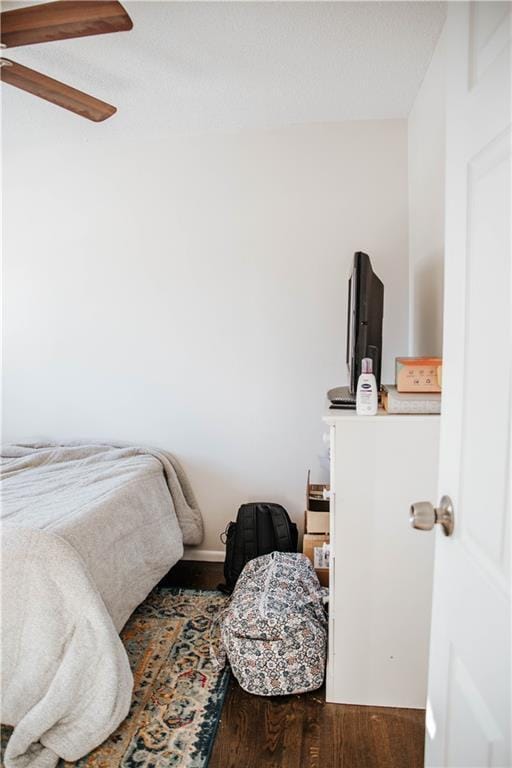 bedroom with ceiling fan and wood-type flooring