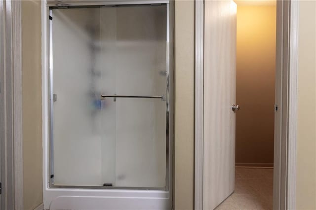 bathroom featuring tile patterned flooring and an enclosed shower