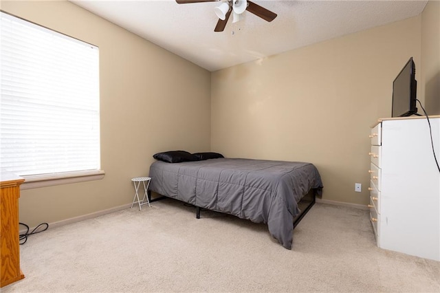 carpeted bedroom featuring vaulted ceiling and ceiling fan