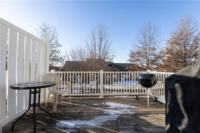 wooden deck with a water view and grilling area