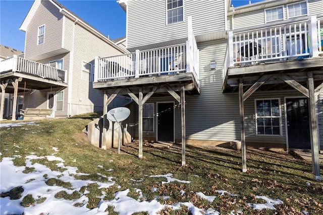 snow covered property with a deck