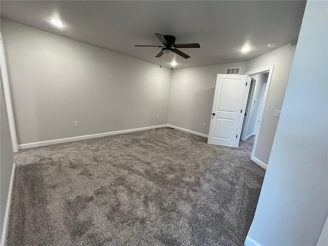 unfurnished room featuring ceiling fan and dark colored carpet