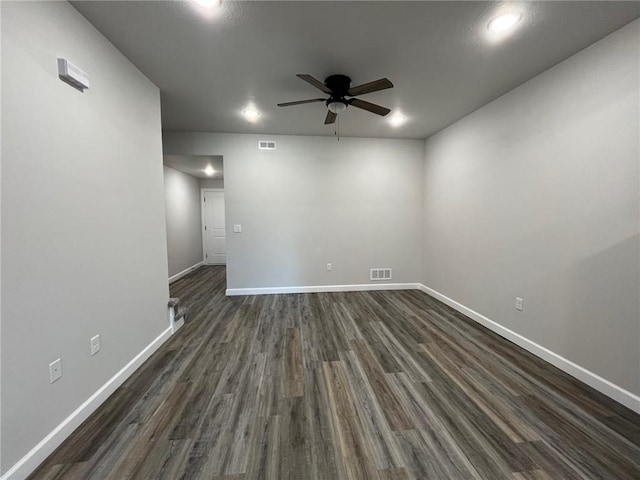 spare room with ceiling fan and dark hardwood / wood-style flooring