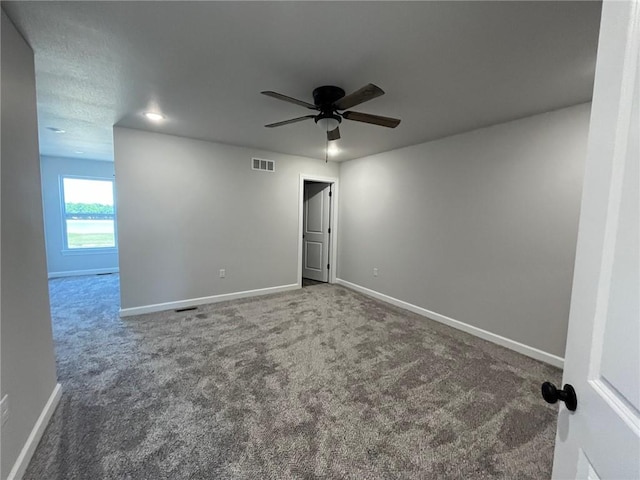 spare room featuring ceiling fan and carpet floors