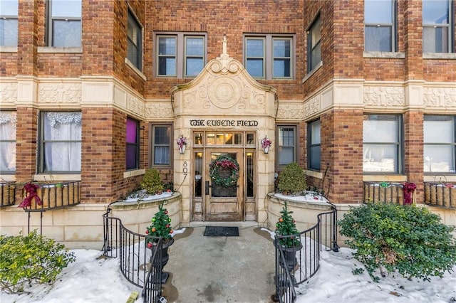 view of snow covered property entrance